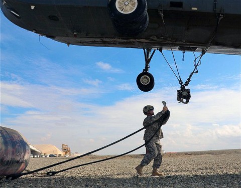 U.S. Army Sgt. Patricia A. Oconnell, a native of Clarksville, TN,  and assigned to Company A, 626th Brigade Support Battalion, 3rd Brigade, 101st Airborne Division, prepares to attach a 500-gallon collapsible fuel bladder to the bottom of a helicopter at Forward Operating Base Sharana here Aug. 7th. Oconnell is the noncommissioned officer in charge of the helicopter landing zone. (Photo by U.S. Army Sgt. Brent C. Powell, 3rd Brigade, 101st Airborne Division)