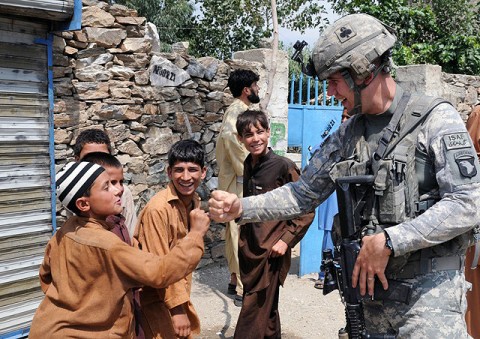 Kunar Province, Afghanistan - U.S. Army Pfc. Gary W. Faust of Bowling Green, Ky., a medic with 4th Platoon, Company D, 1st Battalion, 327th Infantry Regiment, Task Force Bulldog, practices his fist bump with children of Andersil village in eastern Afghanistan's Kunar province July 20th. (Photo by U.S. Army Staff Sgt. Gary A. Witte, 300th Mobile Public Affairs Detachment)