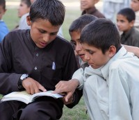 Nangahar Province, Afghanistan – A group of Afghan youth look through a copy of the Boy Scout handbook during their April 24th scout meeting at Forward Operating Base Finley-Shields. The troop, founded in March with the support of village leaders from three different communities in eastern Afghanistan’s Nangahar province, aims to provide kids in the area with discipline and instruction. (Photo by U.S. Army Staff Sgt. Gary A. Witte, 300th Mobile Public Affairs Detachment)