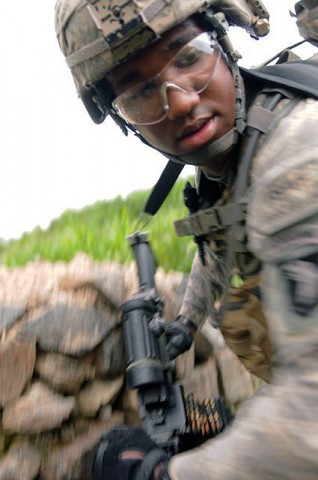 U.S. Army Spc. Nodosky H. Motley of Chicago, a gunner with Company A, 2nd Battalion, 327th Infantry Regiment, Task Force No Slack, moves from cover during an Aug. 18th attack against troops visiting the village of Spinkay in eastern Afghanistan’s Kunar Province. (Photo by U.S. Army Staff Sgt. Gary A. Witte, 300th Mobile Public Affairs Detachment)