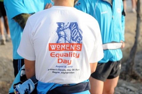 A member of the Republic of Korean Army wears the commemorative T-shirt he earned at the completetion of Bagram Airfield’s Women’s Equality Day five-kilometer run Aug. 26th. (Photo by U.S. Army Pfc. Roy Mercon, Task Force Wolverine Public Affairs)