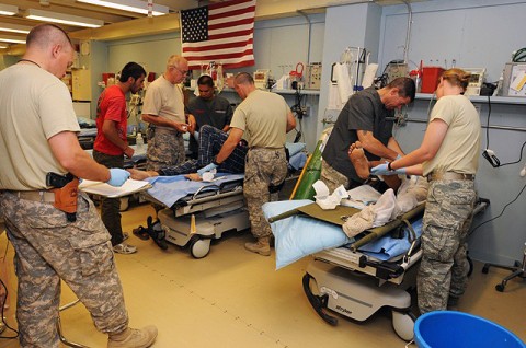 Members of the 934th Forward Surgical Team assess two Afghan patients upon their arrival at Forward Operating Base Sharana Sept. 9th. (U.S. Air Force photo by Master Sgt. Demetrius Lester)