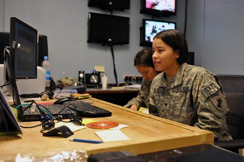 U.S. Army Spc. Jessica A. Walker, of Anoka, MN, noncommissioned officer in charge of psychological operations, assigned to the 319th Tactical Psychological Operations Company, Task Force Bastogne, participates in an online chat session with a teenage female Afghan student in the city of Jalalabad in eastern Afghanistan’s Nangarhar Province Sept. 21st.(Photo by U.S. Army Sgt. Albert L. Kelley, 300th Mobile Public Affairs Detachment)