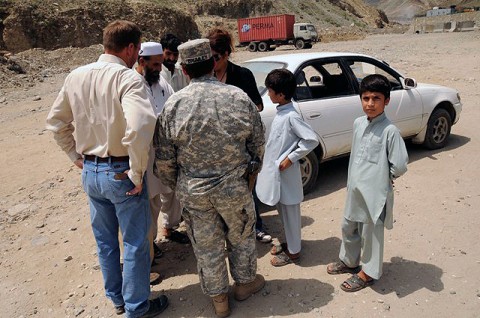 U.S. Army Sgt. 1st Class Melissa Brumley, Iowa National Guard's 734th Agribusiness Development Team, speaks through an interpreter to staff members of the Kunar Province’s Director of Women's Affairs in eastern Afghanistan Aug. 19th after loading their vehicle with supplies for local schoolgirls and clothes for the families of widows in the province. (Photo by U.S. Air Force Capt. Peter Shinn, Kunar Agribusiness Development Team)