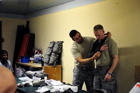 Laghman Provincial Reconstruction Team medics U.S. Air Force Master Sgt. Simon Deyell from Peterson Air Force Base, CO, and U.S. Air Force Senior Airman Jeffrey Marr from Ramstein Air Base, Germany, demonstrate how to use a cravat as a sling during a combat lifesaver refresher course at the PRT barracks Aug. 12th. (Photo by U.S. Air Force Staff Sgt. Ave I. Pele, Laghman Provincial Reconstruction Team Public Affairs) 