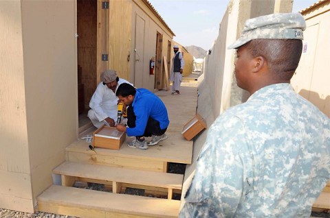 U.S. Army 1st Sgt. Eric Davis, base operations mayor for Forward Operating Base Salerno and company first sergeant for Headquarters and Headquarters Company, 3rd Brigade, 101st Airborne Division, supervises local Afghan workers Sept. 24th at a new billeting site on FOB Salerno. Davis is a native of Grand Rapids, MI. (Photo by U.S. Army Sgt. Brent C. Powell, 3rd Brigade, 101st Airborne Division)