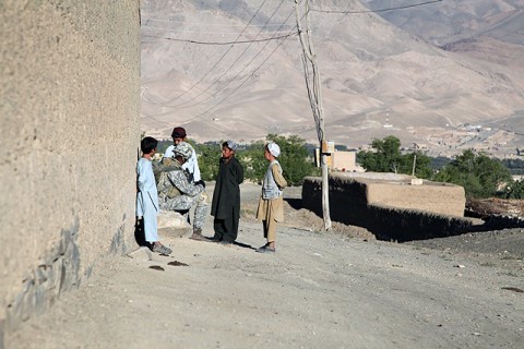 A paratrooper from Attack Company, 1st Battalion, 503rd Infantry Regiment, 173rd Airborne Brigade Combat Team takes time to talk with Afghan children in Chak District, Wardak Province, during Operation Talon Purge Sept. 24th. (U.S. Army courtesy photo)