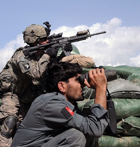 U.S. Army Pfc. Ryan L. Carson of Richmond, Va., a member of the Company Intelligence Support Team with Company A, 1st Battalion, 327th Infantry Regiment, Task Force Bulldog, and an Afghan National Police officer search the nearby hillside just prior to a more than three-hour firefight at the Shege East ANP checkpoint Sept. 18th. (Photo by U.S. Army Staff Sgt. Gary A. Witte, 300th Mobile Public Affairs Detachment)