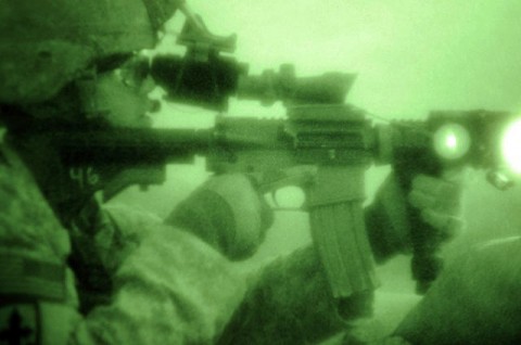 U.S. Army Sgt. Joseph P. Khamvongsa of Mililani, Hawaii, a forward observer with 1st Platoon, Company B, 2nd Battalion, 327th Infantry Regiment, Task Force No Slack, aims his weapon during an insurgent attack on Combat Outpost Badel. (Photo by U.S. Army Staff Sgt. Gary A. Witte, 300th Mobile Public Affairs Detachment)