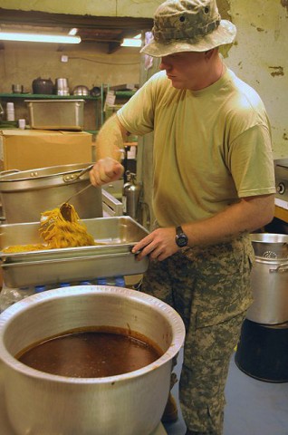 U.S. Army Pvt. Clayton C. Hilderbrand, a Ceres, VA, native stirs noodles while preparing dinner for Soldiers stationed at Forward Operating Base Tillman here Sept. 10th. (Photo by U.S. Army Spc. Luther L. Boothe Jr., Task Force Currahee Public Affairs, 4th Brigade Combat Team, 101st Airborne Division)