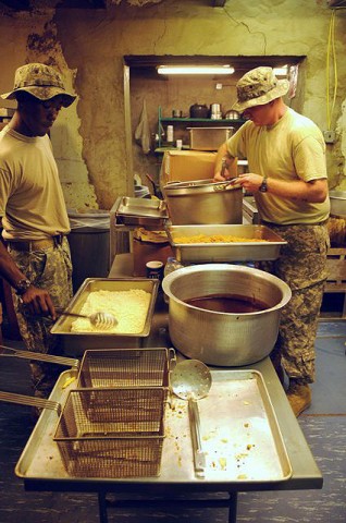 U.S. Army Sgt. Timothy Hunnicutt from Atlanta, and U.S. Army Pvt. Clayton C. Hilderbrand from Ceres, VA, prepare rice and noodles for dinner for Soldiers stationed at Forward Operating Base Tillman here Sept. 10th. (Photo by U.S. Army Spc. Luther L. Boothe Jr., Task Force Currahee Public Affairs, 4th Brigade Combat Team, 101st Airborne Division)