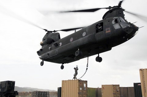 U.S. Army Pvt. Philip C. Brosch, 4th Brigade Combat Team, 101st Airborne Division, braces himself as he prepares to hook up a supply container to a CH-47 Chinook helicopter at Forward Operating Base Orgun-E Sept. 10th. (Photo by U.S. Army Spc. Luther L. Boothe Jr., Task Force Currahee Public Affairs, 4th Brigade Combat Team, 101st Airborne Division)