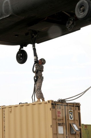 U.S. Army Pvt. Philip C. Brosch, 4th Brigade Combat Team, 101st Airborne Division, hooks up a supply container to a CH-47 Chinook helicopter at Forward Operating Base Orgun-E Sept. 10th. (Photo by U.S. Army Spc. Luther L. Boothe Jr., Task Force Currahee Public Affairs, 4th Brigade Combat Team, 101st Airborne Division)