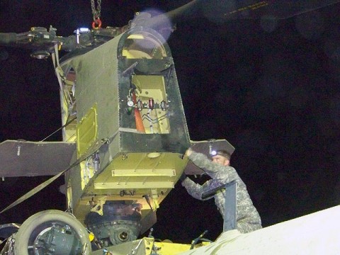 Camp Blackhorse, Afghanistan – U.S. Army Sgt. Jeffery Wafer, a Chinook helicopter repair technician with Company B, Task Force Workhorse, 3rd Combat Aviation Brigade, TF Falcon, from Edgewood, NM, helps remove the aft pylon from a damaged Chinook helicopter July 26th on Camp Blackhorse. (Photo by U.S. Army Maj. Heather Weigner, Task Force Workhorse, 3rd Combat Aviation Brigade, TF Falcon)