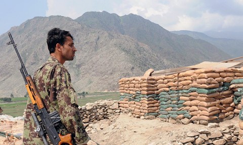 An Afghan soldier with the 6th Kandak stands watch atop Combat Outpost Badel in eastern Afghanistan's Kunar province. The base, occupied by International Security Assistance Forces and the Afghan National Army, overlooks both the Narang and Kunar Valleys. Insurgent forces regularly attack the base as part of their efforts to dominate the area. (Photo by U.S. Army Staff Sgt. Gary A. Witte, 300th Mobile Public Affairs Detachment)