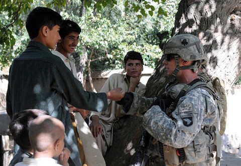 U.S. Army Spc. Robert E. Yates of New Orleans, a team leader with 3rd Platoon, Company D, 1st Battalion, 327th Infantry Regiment, Task Force Bulldog, gives a fist bump to a youth in Samatan village in eastern Afghanistan’s Kunar Province Sept. 24th. (Photo by U.S. Army Staff Sgt. Gary A. Witte, 300th Mobile Public Affairs Detachment)