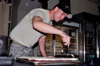 U.S. Army Sgt. Bill McDonald decorates a cake in the Joint Operations Center’s dining facility on Bagram Airfield Oct. 18th. He is especially known for his creative work in cake art. (Photo by U.S. Army Sgt. Scott Davis, Regional Command East Public Affairs)