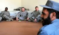 From left, U.S. Army Capt. Thomas Whitfield of Kingstree, SC, U.S. Army Lt. Col. David J. Goetze of Roseau, MN, and U.S. Army Capt. Robert R. Reynolds of Huntsville, Ala., meet with Afghan police officers and the Watapur District sub-governor here Sept. 25th. Goetze commands the Kunar Security Forces Assistance Team, Task Force Bastogne. Officials discussed local law enforcement and how International Security Forces could help. (Photo by U.S. Army Staff Sgt. Gary A. Witte, 300th Mobile Public Affairs Detachment)