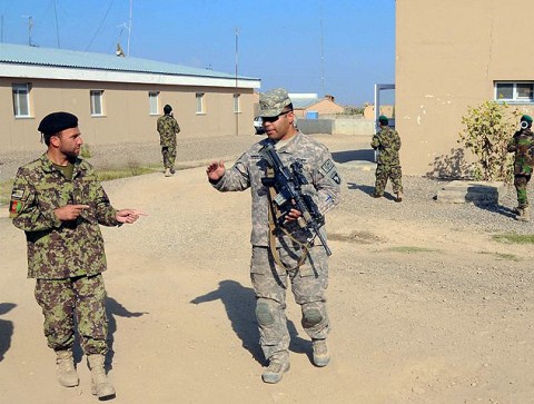 U.S. Army Sgt. Pedro Rodriguez-Ortiz, a native of Los Angeles, CA, and a squad leader for 1st Squad, 1st Platoon, Company C, 1st Squadron, 33rd Cavalry, discusses squad movement techniques with his Afghan counterpart Staff Sgt. Zaratgul Tofan, an Afghan National Army squad leader and native of Kabul Province, during patrol training at Camp Parsa Oct. 4th. (Photo by U.S. Army Staff Sgt. Brent C. Powell, 3rd Brigade, 101st Airborne Division)