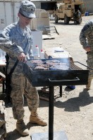 U.S. Army Spc. Jian Guo Wang, a food service specialist with Headquarters Company, 801st Brigade Support Battalion, 4th Brigade Combat Team, 101st Airborne Division and native of Brooklyn, NY, grills steaks for Task Force Currahee Soldiers, deployed to Combat Outpost Munoz Sept 26th.  (Photo by U.S. Army Spc. Luther L. Boothe Jr., Task Force Currahee Public Affairs Office)