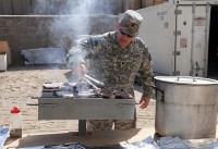 As part of the Steak and Ice Cream Express mission to boost morale for Soldiers at remote bases, U.S. Army Lt. Col. David Preston, commander of the 801st Brigade Support Battalion, 4th Brigade Combat Team, 101st Airborne Division, grills steaks Oct. 20th. (Photo by U.S. Army Spc. Christina Sinders, Task Force Currahee Public Affairs)