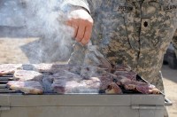 As part of the Steak and Ice Cream Express mission to boost morale for Soldiers at remote bases, U.S. Army Lt. Col. David Preston, commander of the 801st Brigade Support Battalion, 4th Brigade Combat Team, 101st Airborne Division, grills steaks Oct. 20th. (Photo by U.S. Army Spc. Christina Sinders, Task Force Currahee Public Affairs)