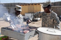 As part of the Steak and Ice Cream Express mission to boost morale for Soldiers at remote bases, U.S. Army Chief Warrant Officer Amanda Milstead and U.S. Army Pvt. Chyanne Easter, food specialists with the 801st Brigade Support Battalion, 4th Brigade Combat Team, 101st Airborne Division, grill steaks Oct. 20th, (Photo by U.S. Army Spc. Christina Sinders, Task Force Currahee Public Affairs)