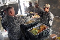 As part of the Steak and Ice Cream Express mission to boost morale for Soldiers at remote bases, U.S. Army Lt. Col. David Preston, commander of the 801st Brigade Support Battalion, 4th Brigade Combat Team, 101st Airborne Division, serves steak, coleslaw, potato salad and ice cream Oct. 20th. (Photo by U.S. Army Spc. Christina Sinders, Task Force Currahee Public Affairs)
