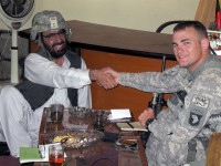 U.S. Army 2nd Lt. Brian Rowan, a member of Support Platoon, Headquarters and Headquarters Company, 1st Special Troops Battalion, Task Force Spartan, and native of Langhorne, PA, shares a laugh with the District Development Assembly Chief Malik Niamat in the Behsood District here Oct. 4th. Rowan talked with Niamat about what projects will be discussed at the next DDA meeting. (Photo by U.S. Army Staff Sgt. William Smith, Task Force Spartan)