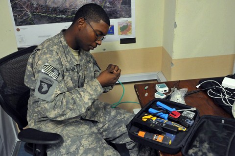 U.S. Army Pfc. Derek A. Gamlin of Kosciusko, MS, a Task Force Bastogne information management officer with Headquarters and Headquarters Company, TF Bastogne’s communication shop, fixes an internet cable Oct. 19th. The shop repairs and maintains communications equipment and provides expert advice to her battalions in eastern Afghanistan’s Nangarhar Province. (Photo by U.S. Army Spc. Richard Daniels Jr., Task Force Bastogne Public Affairs)