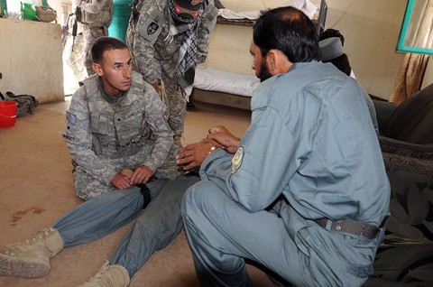 U.S. Army Spc. Jared Shiflet, a combat medic and native of Tampa, FL, assigned to the 330th Military Police Company, demonstrates to an Afghan National Policeman how to apply a tourniquet at the Mandowzai District Center Oct. 7th. Shiftlet and the other Soldiers of his unit are helping to train and advise nearly 300 ANP. (Photo by U.S. Army Staff Sgt. Brent C. Powell, 3rd Brigade, 101st Airborne Division)