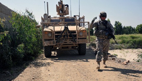 U.S. Army Sgt. 1st Class Derek L. Ashman, of San Diego, a platoon sergeant with 1st Platoon, Company D, 2nd Battalion, 327th Infantry Regiment, Task Force Spartan, guides an mine resistant ambush protected all-terrain vehicle along a narrow road Sept. 26th. Ashman’s platoon was visiting a local farmer whose crops had been partially damaged earlier in the month by a military vehicle. (Photo by U.S. Army Sgt. Albert L. Kelley, 300th Mobile Public Affairs Detachment)