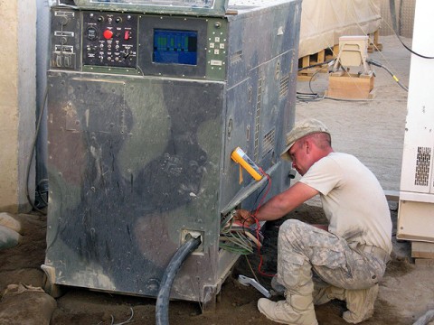 U.S. Army Spc. Steven Carter, works on one of the generators to maintain stable power flow through Forward Operating Base Andar. The original establishment of the FOB provided small generators for each primary building. The reorganized power system allows the FOB to operate using generators. (Photo by U.S. Army 1st Lt. R.J. Peek, 3rd Battalion, 187th Infantry, 101st Airborne Division)