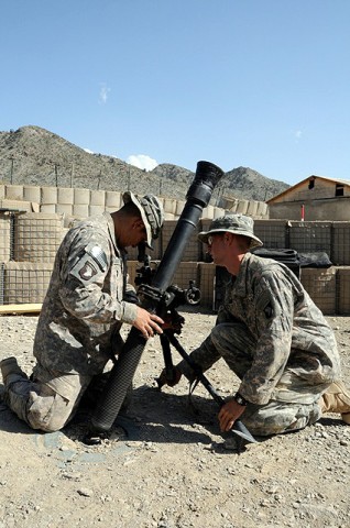 U.S. Army Pfc. Armando J. Ramos, a mortarman with the 101st Airborne Division, and U.S. Army Spc. Michael W. Dough, a mortarman also with the Airborne Div., prepare to run a crew drill Sept. 27th on Combat Outpost Munoz. (Photo by U.S. Army Spc. Luther L. Boothe Jr., Task Force Currahee Public Affairs Office)