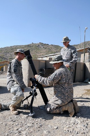 U.S. Army Pfc. Armando J. Ramos, a mortarman with the 101st Airborne Division, and U.S. Army Spc. Michael W. Dough, a mortarman also with the 101st Airborne Div., are inspected by U.S. Army Sgt. David A. Ramirez, Sept. 27th on Combat Outpost Munoz. (Photo by U.S. Army Spc. Luther L. Boothe Jr., Task Force Currahee Public Affairs Office)