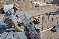 U.S. Army Sgt. David A. Ramirez, the noncommissioned officer in charge of mortar operations from Company D, 2nd Battalion, 506th Infantry Regiment, 4th Brigade Combat Team, 101st Airborne Division, and native of San Antonio, and U.S. Army Pfc. Armando J. Ramos, a mortarman with D Co., 2-506th Inf. Reg., 4th BCT, 101st Airborne Div., and native of Victorville, CA, reinforce a mortar fighting position Sept. 27th on Combat Outpost Munoz. (Photo by U.S. Army Spc. Luther L. Boothe Jr., Task Force Currahee Public Affairs Office)