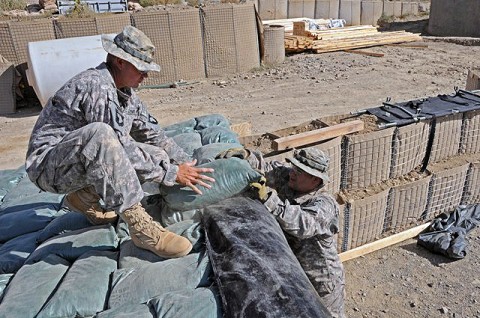 U.S. Army Sgt. David A. Ramirez, the noncommissioned officer in charge of mortar operations from Company D, 2nd Battalion, 506th Infantry Regiment, 4th Brigade Combat Team, 101st Airborne Division, and native of San Antonio, and U.S. Army Pfc. Armando J. Ramos, a mortarman with D Co., 2-506th Inf. Reg., 4th BCT, 101st Airborne Div., and native of Victorville, CA, reinforce a mortar fighting position Sept. 27th on Combat Outpost Munoz. (Photo by U.S. Army Spc. Luther L. Boothe Jr., Task Force Currahee Public Affairs Office) U.S. Army Sgt. David A. Ramirez, the noncommissioned officer in charge of mortar operations from Company D, 2nd Battalion, 506th Infantry Regiment, 4th Brigade Combat Team, 101st Airborne Division, and native of San Antonio, and U.S. Army Pfc. Armando J. Ramos, a mortarman with D Co., 2-506th Inf. Reg., 4th BCT, 101st Airborne Div., and native of Victorville, CA, reinforce a mortar fighting position Sept. 27th on Combat Outpost Munoz. (Photo by U.S. Army Spc. Luther L. Boothe Jr., Task Force Currahee Public Affairs Office)