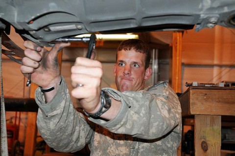 U.S. Army Sgt. Craig Hayward, powertrain mechanic and native of Huntingtown, MD, assigned to Company D, Task Force Viper attempts to loosen a bolt on a rotor head from an AH-64 Apache helicopter on Forward Operating Base Salerno. The mechanics helped pilots log nearly 26,000 hours of flying time. (Photo by U.S. Army Staff Sgt. Brent C. Powell, 3rd Brigade, 101st Airborne Division)