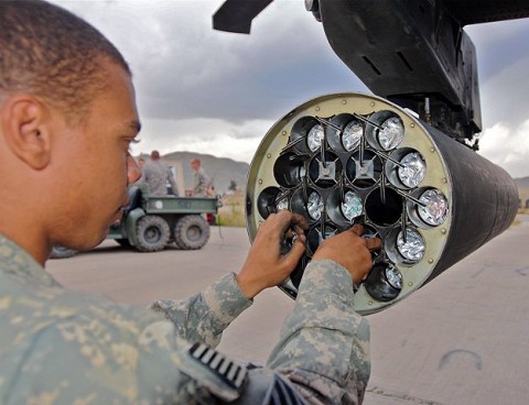 U.S. Army Spc. Spencer Riddick, an AH-64 Apache helicopter armament, electronics and avionics repairer from Ridgecrest, CA, assigned to Company D, Task Force Viper ensures rockets are locked into place on a rocket pod beneath an Apache on Forward Operating Base Salerno Sept. 30th. (Photo by U.S. Army Staff Sgt. Brent C. Powell, 3rd Brigade, 101st Airborne Division)