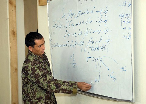 An Afghan National Army soldier enrolled in the Team Leader Course on Forward Operating Base Thunder, Paktya Province, answers a mathematics problem Oct. 17th. The first week of the Team Leader Course is dedicated to literacy and basic education, a first opportunity for many ANA Soldiers. (Photo by U.S. Army Sgt. Spencer Case,  304th Public Affairs Detachment)