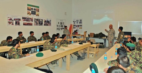 U.S. Army Spc. Tom Schenk, a combat medic and native of Chula Vista, CA, assigned to Headquarters, 1st Squadron, 33rd Cavalry Regiment, shows a slide of a compound fracture to Afghan National Army soldiers enrolled in a five-day combat life saver course at Camp Parsa Oct. 5th. (Photo by U.S. Army Staff Sgt. Brent C. Powell, 3rd Brigade, 101st Airborne Division)