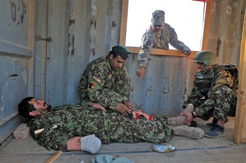 U.S. Army Spc. Tom Schenk, a combat medic and native of Chula Vista, CA, assigned to Headquarters, 1st Squadron, 33rd Cavalry Regiment, gives directions on how to apply a splint to Afghan National Army soldiers enrolled in a five-day combat life saver course on Camp Parsa Oct. 5th. The students were learning to treat simulated casualties. (Photo by U.S. Army Staff Sgt. Brent C. Powell, 3rd Brigade, 101st Airborne Division)