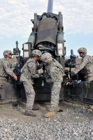 U.S. Army Spc. Justin A. Brown of Oklahoma City, a cannoneer, and U.S. Army Spc. Dylan T. Smith of Columbus, Ohio, ammo team chief, both with 1st Section, 1st Platoon, Battery A, 2nd Battalion, 320th Field Artillery Regiment, simulate loading a round into their howitzer at Forward Operating Base Garcia Sept. 29th. (Photo by U.S. Army Spc. Richard Daniels Jr., Task Force Bastogne Public 