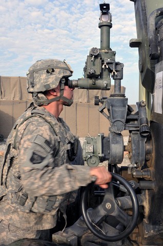 U.S. Army Pfc. Justin F. Nowak of Huston, 1st Section, 1st Platoon, Battery A, 2nd Battalion, 320th Field Artillery Regiment, sights onto his aiming reference at Forward Operating Base Garcia Sept. 29th. (Photo by U.S. Army Spc. Richard Daniels Jr., Task Force Bastogne Public Affairs)