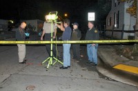 Crimescene team members discussing strategy and mapping the scene.