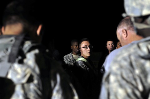 Spc. Sean Harney, A Company, Task Force Troubleshooter Movement Control Team pax runner, conducts a roll-call of passengers before escorting them to a CH-47 Chinook helicopter at Kandahar Airfield, Afghanistan. The soldier in charge of the mission will conduct two different role calls before the flight