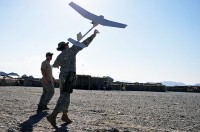 U.S. Army Sgt. Adam M. Hawes, of Pittsburgh, PA, a squad leader with the military police platoon, Headquarters and Headquarters Company, 1st Special Troops Battalion, Task Force Spartan, launches a Raven unmanned aircraft system at Combat Outpost Garcia here Oct. 2nd. (Photo by U.S. Army Sgt. Albert L. Kelley, 300th Mobile Public Affairs Detachment)