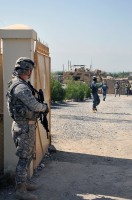 U.S. Army Sgt. 1st Class Derek L. Ashman of San Diego, platoon sergeant of 1st Platoon, Company D, 2nd Battalion, 327th Infantry Regiment, Task Force No Slack secures a gate during a Sept. 26th key leader engagement. (Photos by U.S. Army Spc. Richard Daniels Jr., Task Force Bastogne Public Affairs)