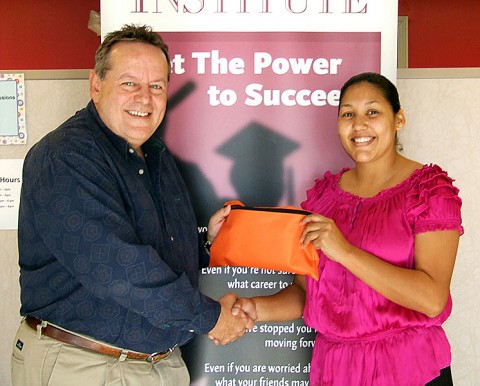 Art Conn, left, representing Ad One Advertising and Crisis 211, accepts a bag of money collected at the Clarksville Playdate to donate to the Crisis 211, from Yasmine Carrion, right, Community Relations Specialist for Daymar Institute. The event was sponsored by Daymar Institute, Trane, Ad One Advertising and Little Caesar’s Pizza.