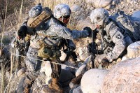 U.S. Army Sgt. James Small (right), a cavalry scout from Milton, FL, with Troop A, 1st Squadron, 61st Cavalry Regiment, helps U.S. Army Spc. Andreas Plaza, a combat medic from Freeport, NY, with Headquarters and Headquarters Troop, 1st Squadron, 61st Cavalry Regiment, up a mountainside in the Towr Gahr Pass here Nov. 6th. (Photo by U.S. Army Staff Sgt. Ryan C. Matson, Task Force Bastogne Public Affairs, 210th Mobile Public Affairs Detachment)